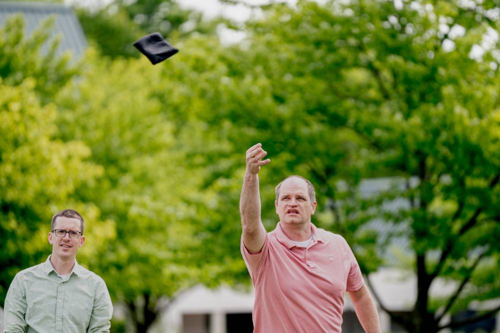 A play throws a bag and watches if fly through the trees